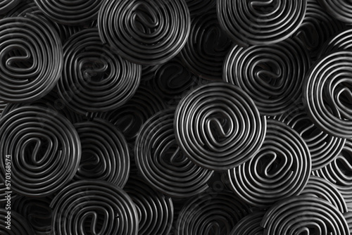 Stacks of circularly rolled black liquorice. Illustration of the concept of herbalism and medical use of liquorice and as a design background for web and presentation photo