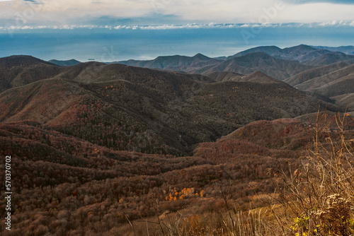 A landscape of mountains with beautiful Caucasian nature. View from a great height in a picturesque place of the Caucasus. The mountain range of the Caucasus against the background of clouds.