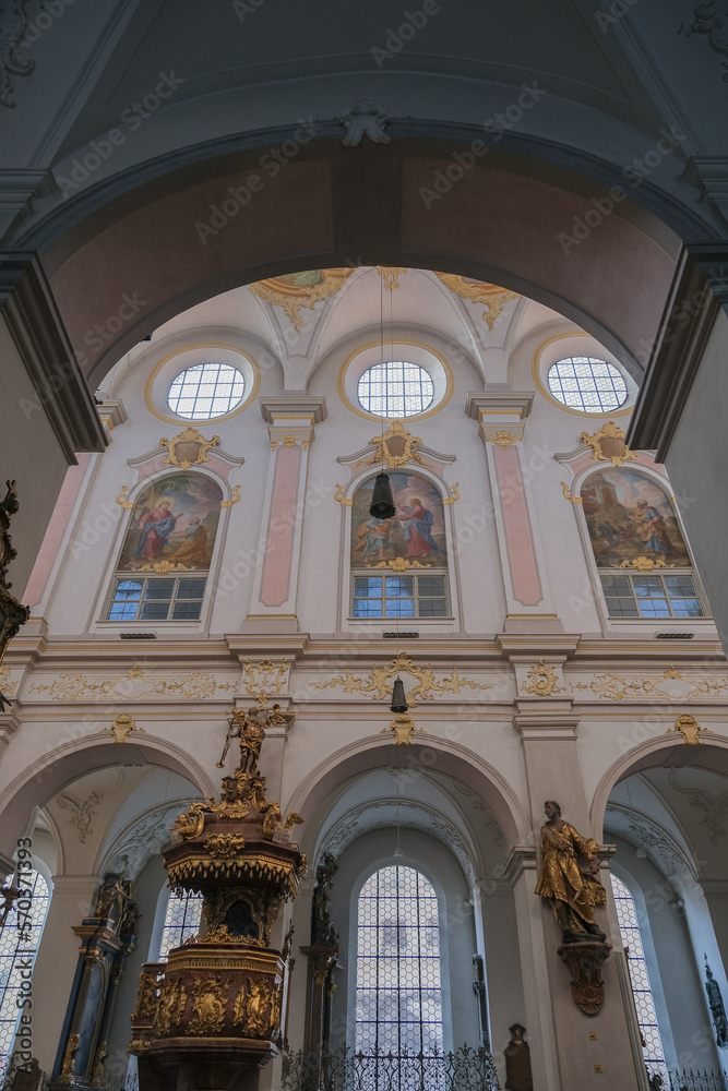Magnificent opulent splendid Bavarian baroque church cathedral basilica interiors with stucco, murals, altar, Pilars, ceiling paintings, gold, wood domes nave	
