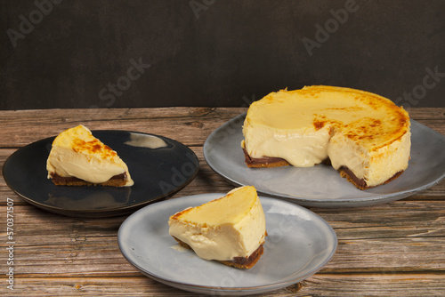 cheesecake in slices on a brown wooden table