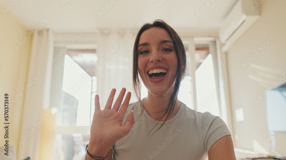 Young woman talking on video call using laptop while sitting in apartment Young woman talking on video call using laptop while sitting in apartment