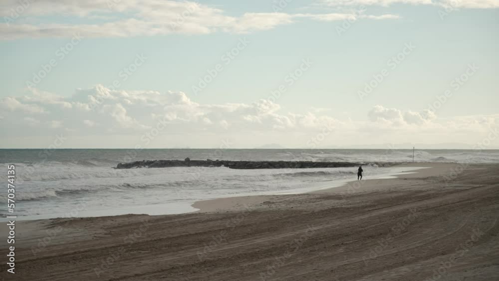 woman taking photo of the sea in winter woman taking photo of the sea in winter