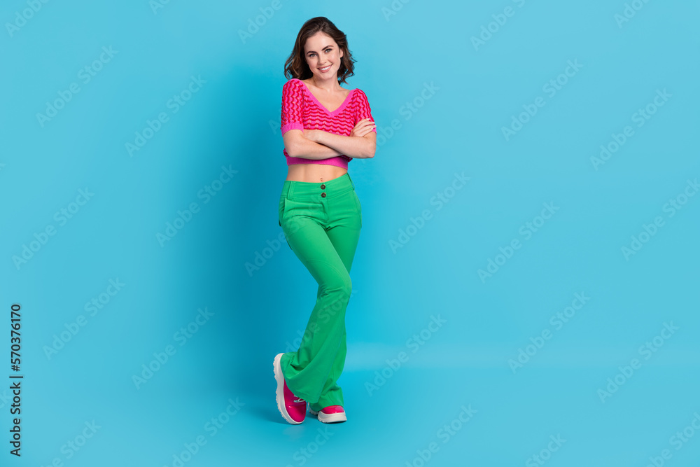 Full size photo of fancy lovely sweet nice woman with wavy hairstyle wear pink top hold arms folded isolated on blue color background Full size photo of fancy lovely sweet nice woman with wavy hairstyle wear pink top hold arms folded isolated on blue color background