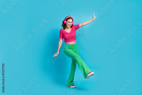 Full size photo of good mood girlish woman with wavy hairstyle wear pink top dancing eyes closed isolated on blue color background