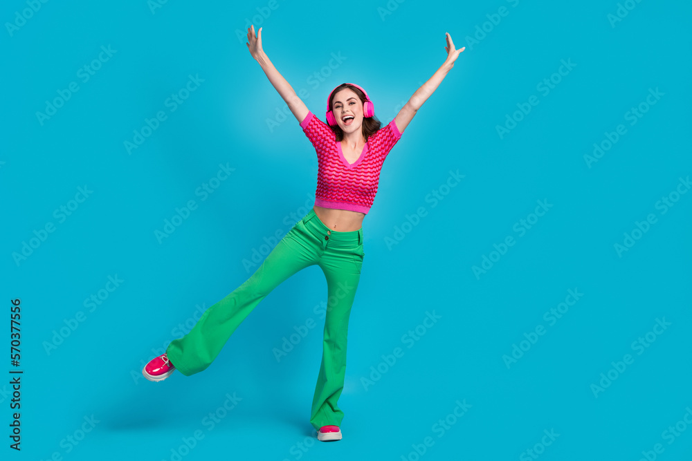 Full length photo of overjoyed crazy lady wear stylish pink clothes raise hands good mood empty space isolated on blue color background