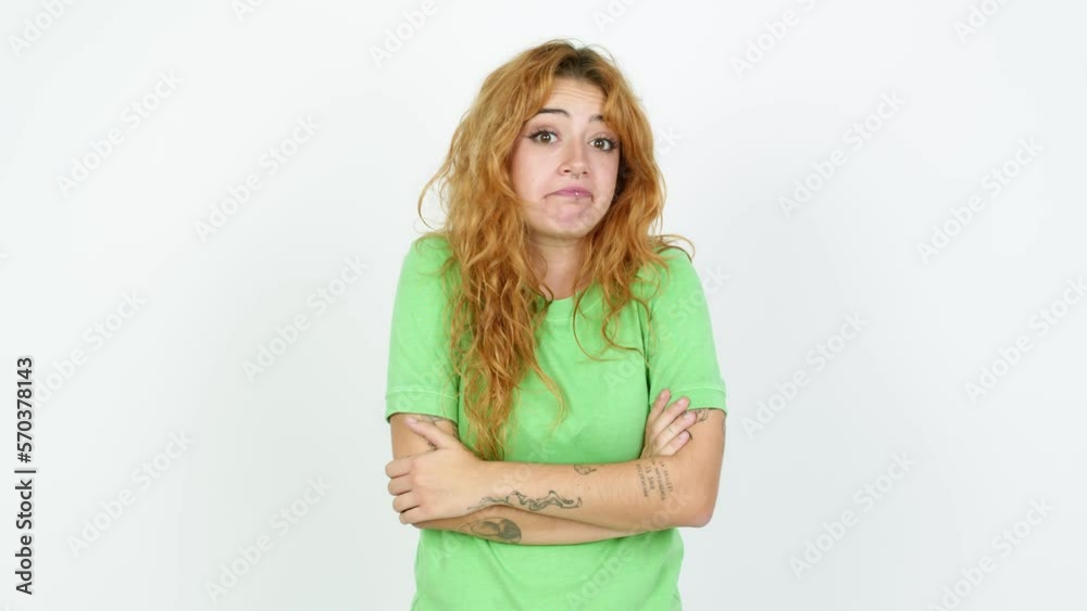 Young redhead woman making unimportant and doubts gesture while lifting the shoulders and the palms of the hands over isolated background Young redhead woman making unimportant and doubts gesture while lifting the shoulders and the palms of the hands over isolated background