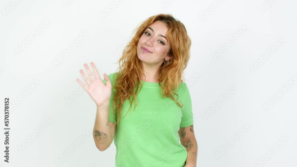 Young redhead woman saluting with hand with happy expression over isolated background Young redhead woman saluting with hand with happy expression over isolated background
