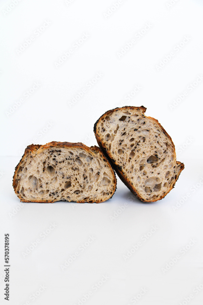Sliced sourdough bread with black sesame seeds, white background Sliced sourdough bread with black sesame seeds, white background