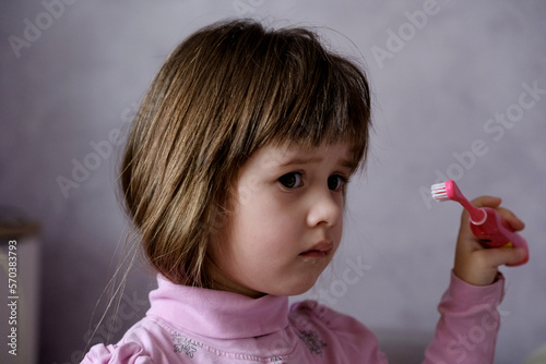 Little girl brushing her teeth. Oral hygiene. Girl with a toothbrush.
