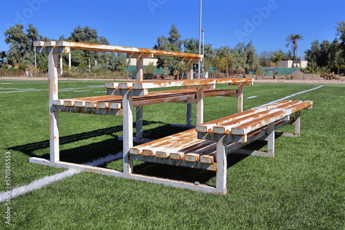 Old portable and rusty bleachers of three levels on a sports ground