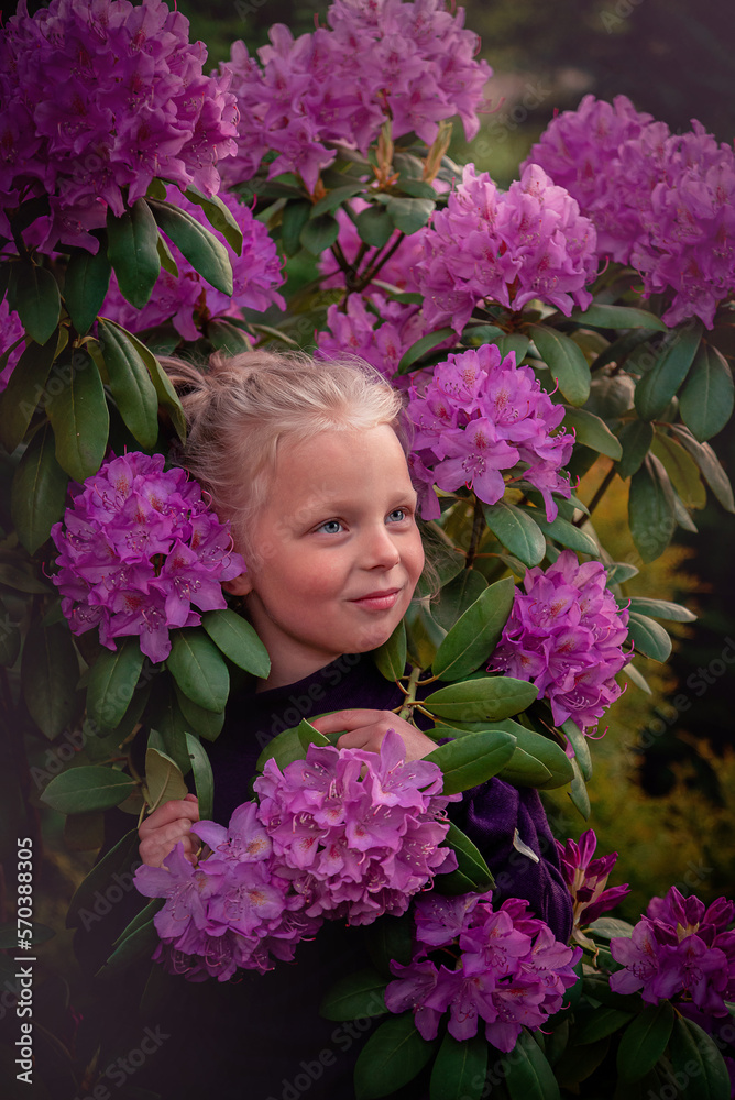Portrait of a girl in purple rhododendron flowers Portrait of a girl in purple rhododendron flowers
