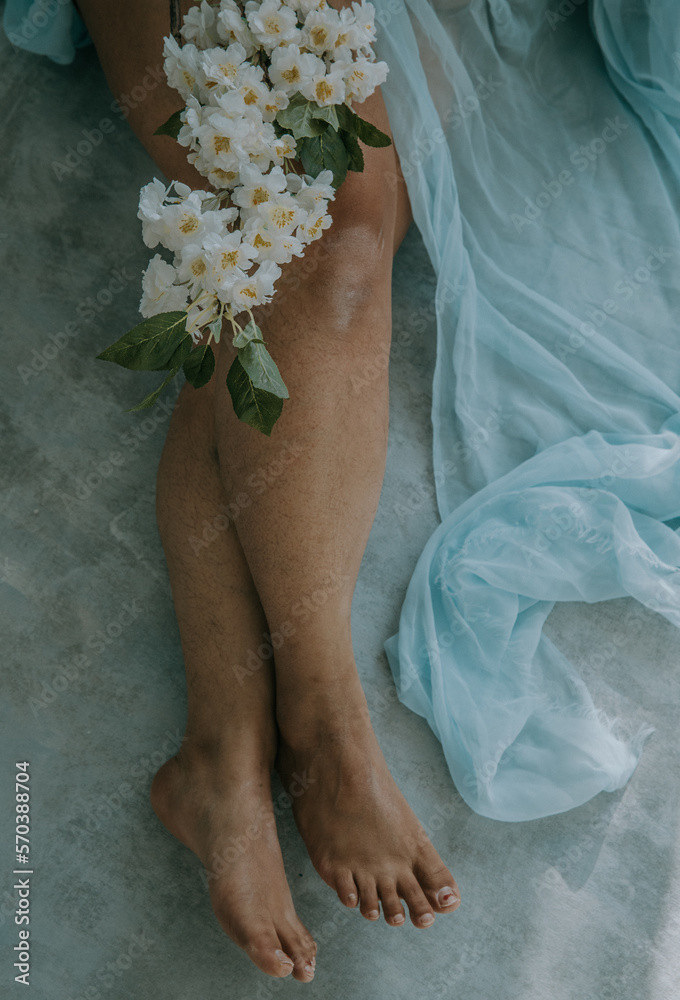 close up of white blossoms on East Indian woman's legs