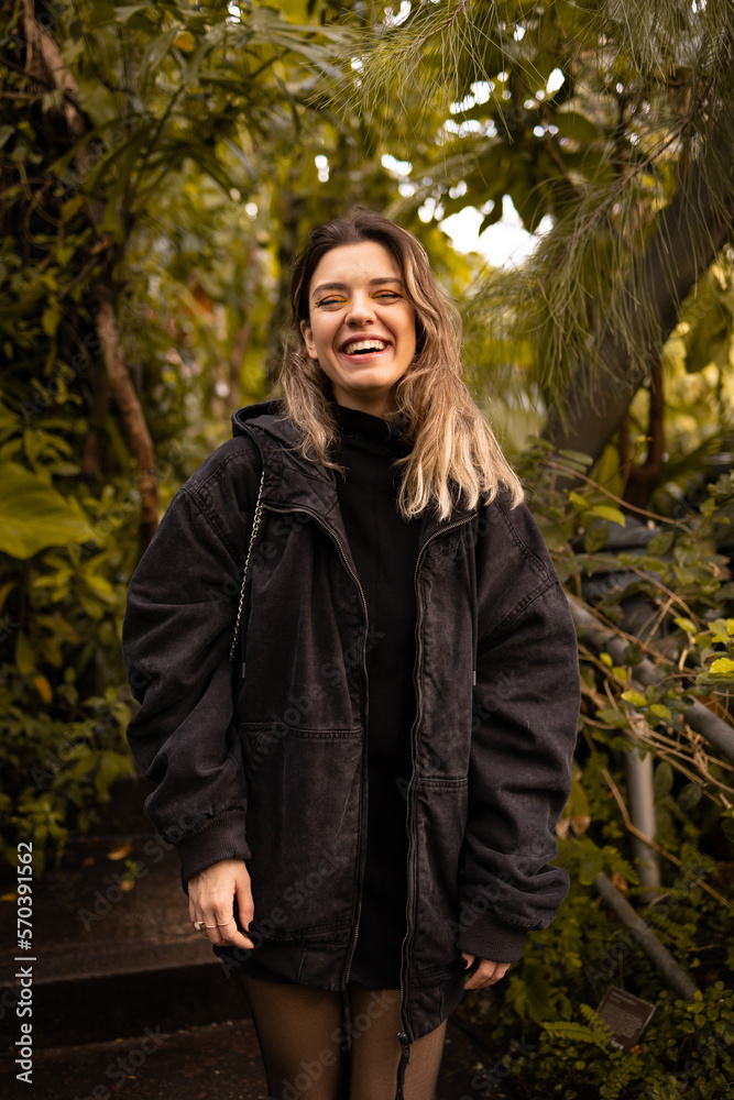 Young beautiful woman looking at camera and laughing. Attractive beautiful girl. Nature love and fresh air concept. Young beautiful woman looking at camera and laughing. Attractive beautiful girl. Nature love and fresh air concept.