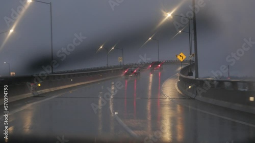 Driving on bridge at night in rain