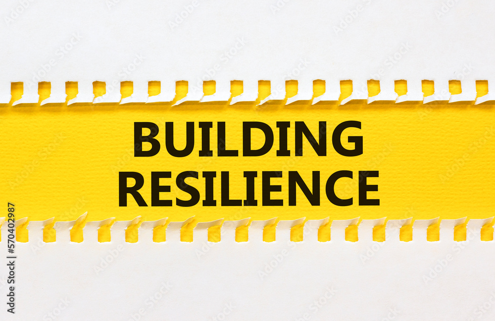 Obraz premium Building resilience symbol. Concept word Building resilience typed on yellow and white paper. Beautiful yellow and white background. Business and building resilience concept. Copy space.