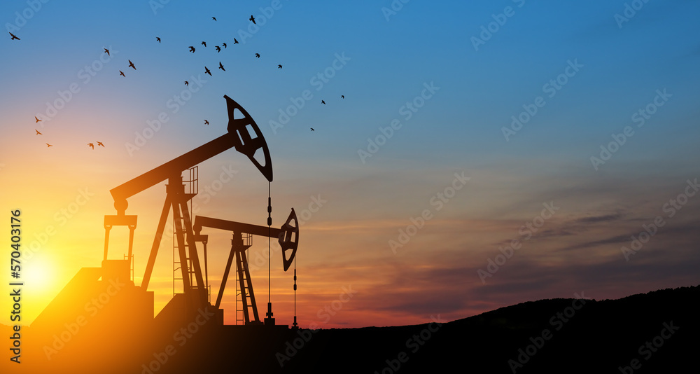 Fototapeta premium The change in oil prices caused by the war. Oil prices are rising because of the global crisis. Oil drilling derricks at desert oilfield. Crude oil production from the ground. Petroleum production.