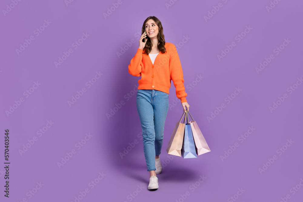 Full length photo of cute dreamy woman dressed cardigan talking gadget bargains empty space isolated purple color background