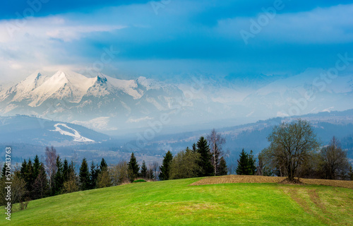 Fototapeta Naklejka Na Ścianę i Meble -  View of the Tatra Mountains from the viewpoint on Czarna Góra. It's spring in the valleys, and winter high in the mountains.