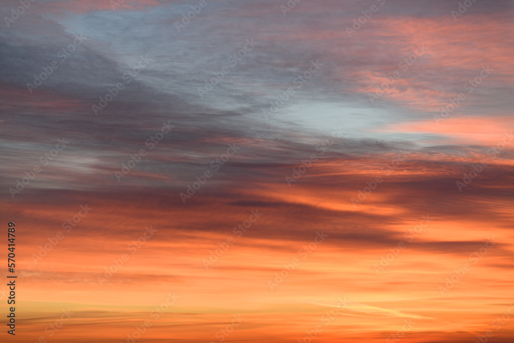 Sky with soft and fluffy pastel orange pink and blue colored clouds. Sunset background. Nature. sunrise. Instagram toned style