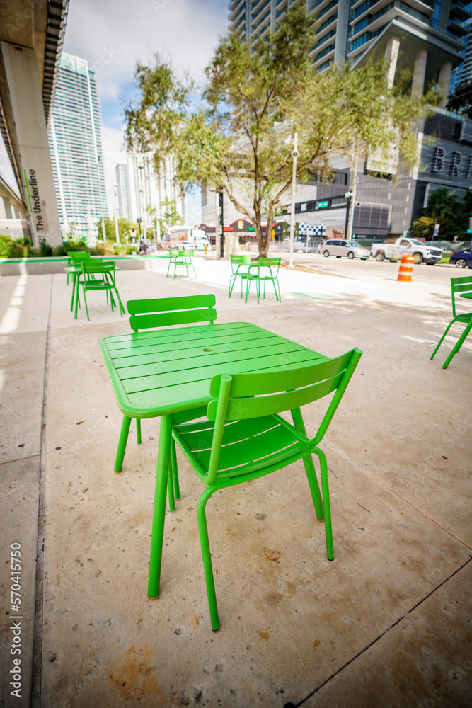 Public green tables and chairs at the Brickell Underline Miami