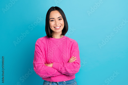 Photo of cheerful cute person beaming smile crossed arms empty space isolated on blue color background