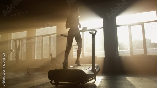 Back view of healthy woman jogging and sprinting for building slim and muscular legs. Female athlete performing high intensity cardiovascular training. High quality 4k footage
