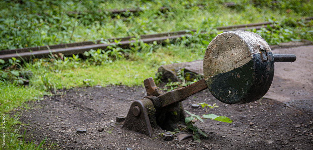 An old hand operated track switch with weight. There is no longer a connection to the track. An old hand operated track switch with weight. There is no longer a connection to the track.