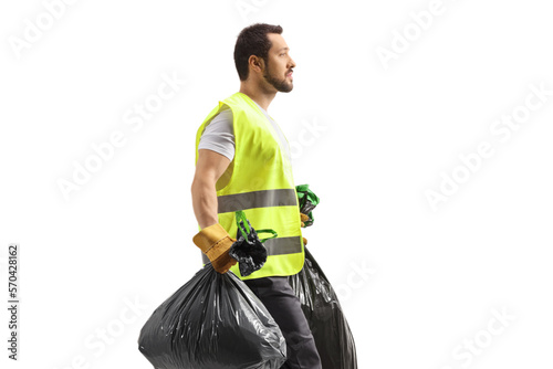 Profile shot of a waste collector walking and carrying bin bags