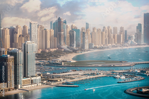 Dubai Marina. Beaches and Dubai Eye view at sunset with boats and yachts in the Persian gulf 