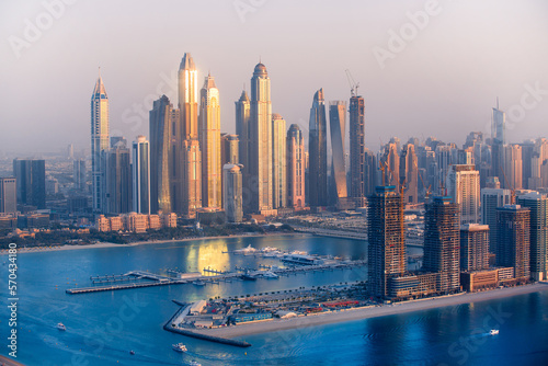 Dubai Marina skyscrapers view at golden sunset with beautiful reflection in water. Dubai, UAE. © IRStone