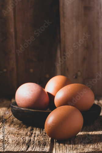 pile of eggs on rustic wood, close-up image photo