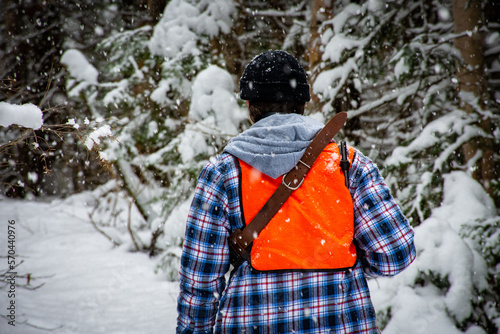 Young man hunting small game in the forest on a cold winter day