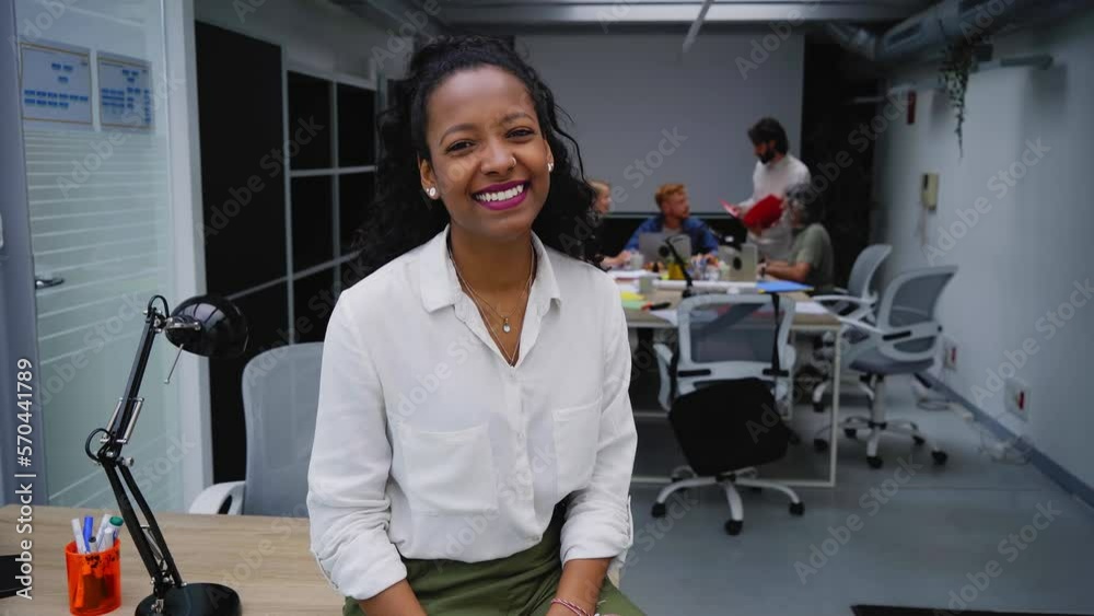 Video of smiling young African American professional female sitting at ...