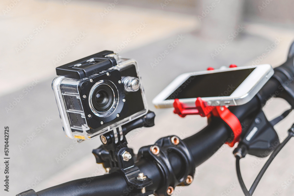 A bike with an action camera and a phone on the city.