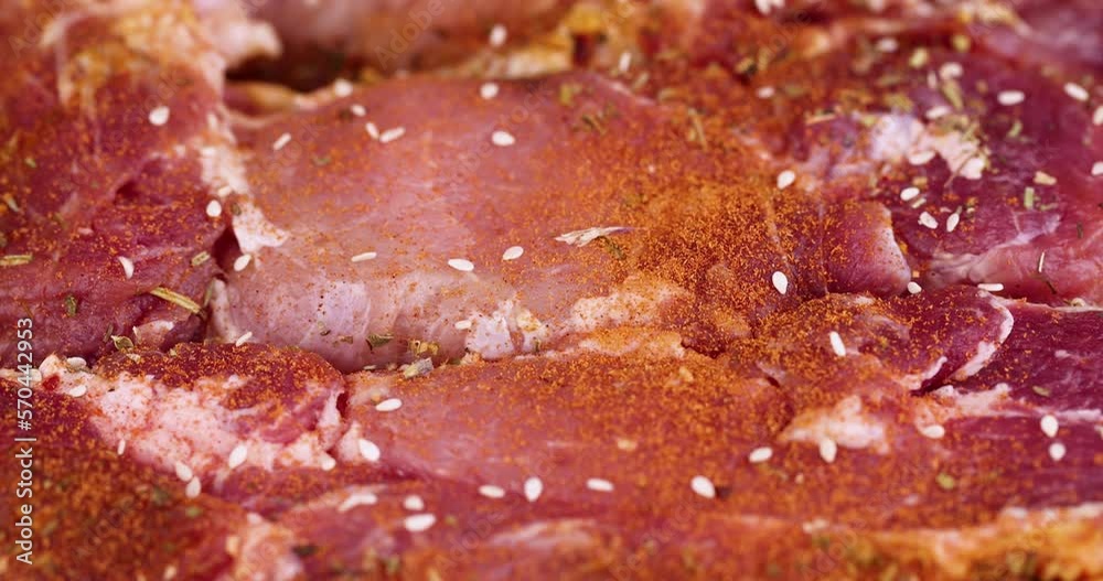 Sprinkle marinated pork meat with sesame spices, preparing pork neck meat for barbecue Sprinkle marinated pork meat with sesame spices, preparing pork neck meat for barbecue