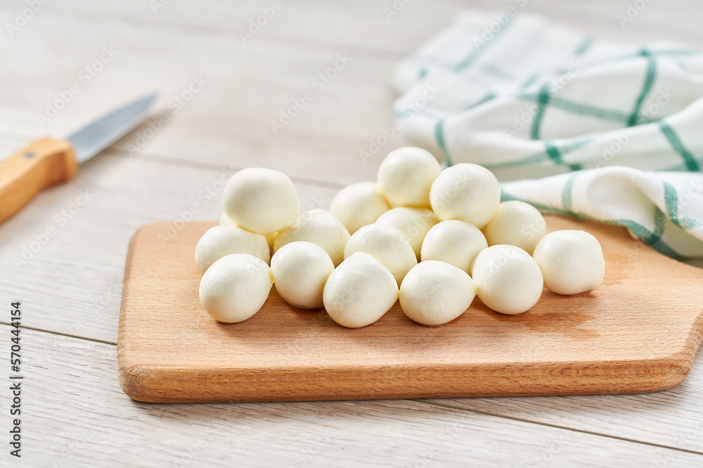 mini mozzarella cheese balls on a kitchen table,with copy space for text. mini mozzarella cheese balls on a kitchen table,with copy space for text.