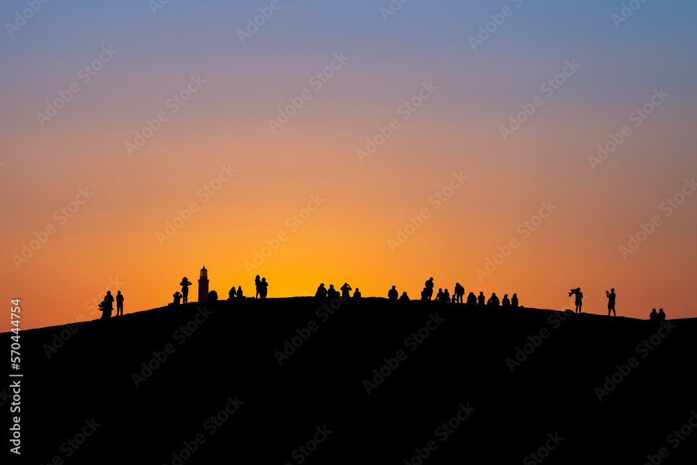 Sunset at Maspalomas Dunes - people shadows at clear sky at sunset