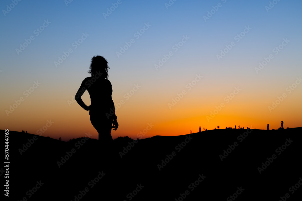 Sunset at Maspalomas Dunes - woman shadow at clear sky at sunset