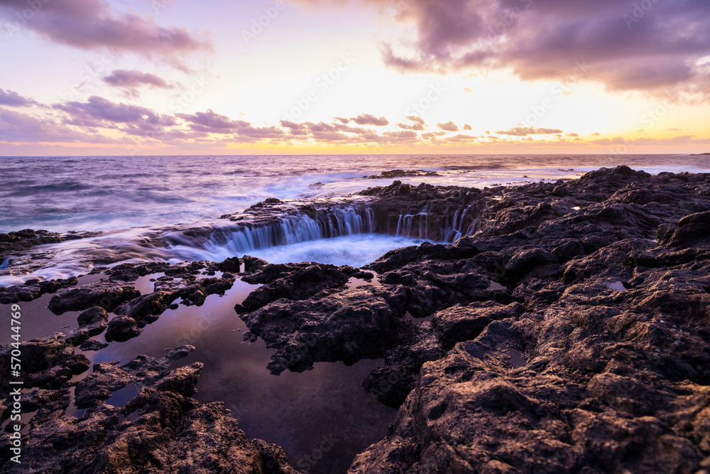 Sunset at El Bufadero natural blowhole on Gran Canaria. Ocean waves hiting rocks.