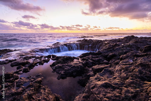 Sunset at El Bufadero natural blowhole on Gran Canaria. Ocean waves hiting rocks.