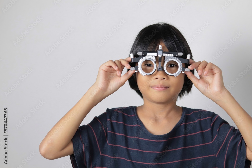 Kid wearing trial frame eyeglasses Kid wearing trial frame eyeglasses