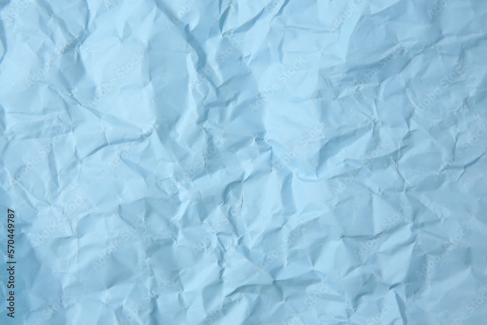 Sheet of crumpled light blue paper as background, top view Sheet of crumpled light blue paper as background, top view
