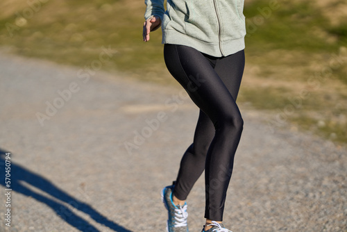 close up of unrecognizable sportswoman running on a sunny afternoon
