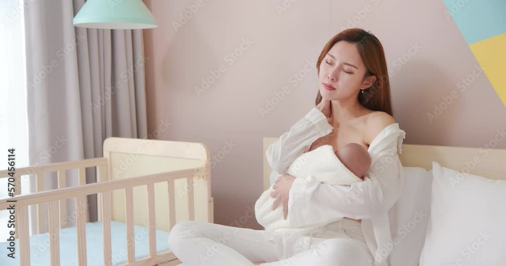 tired mother breastfeeding baby