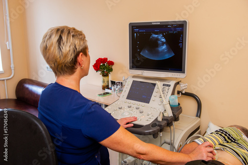 VINNITSA,UKRAINE .OCTOBER 25 of 2022:Medical specialists near ultrasound machine in the hospital ward.