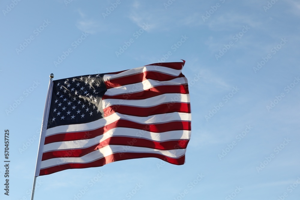 Obraz premium American flag fluttering outdoors on sunny day