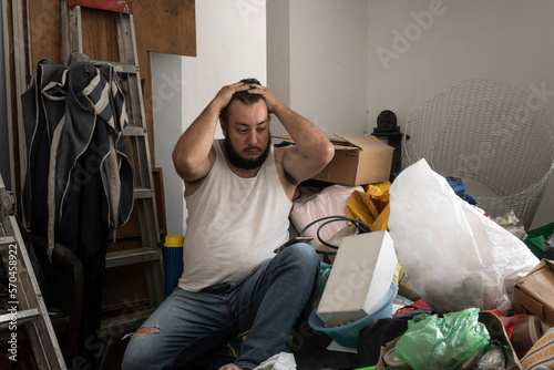 person with hoarding disorder depressed in his messy room