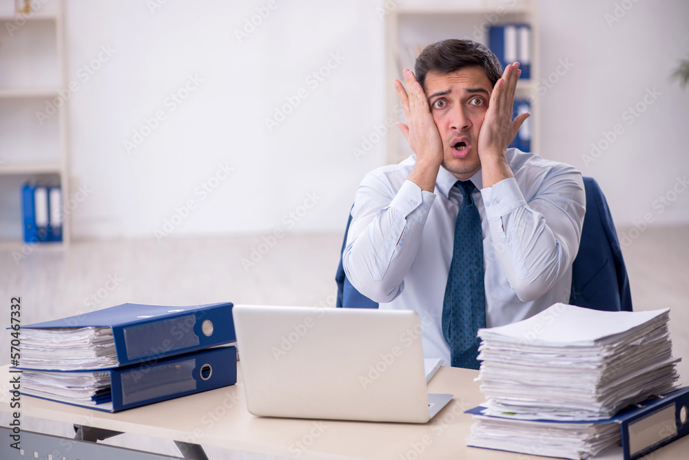 Young male employee working in the office Young male employee working in the office