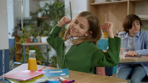 Elementary school class children communicate with the teacher answering question
