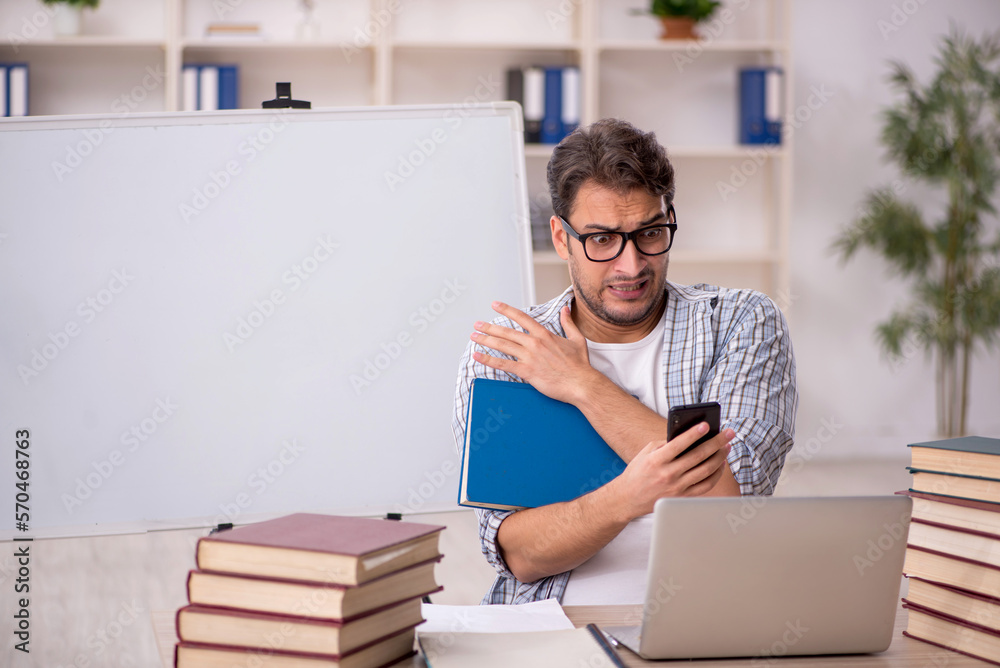 Young male student preparing for exams in the classroom Young male student preparing for exams in the classroom